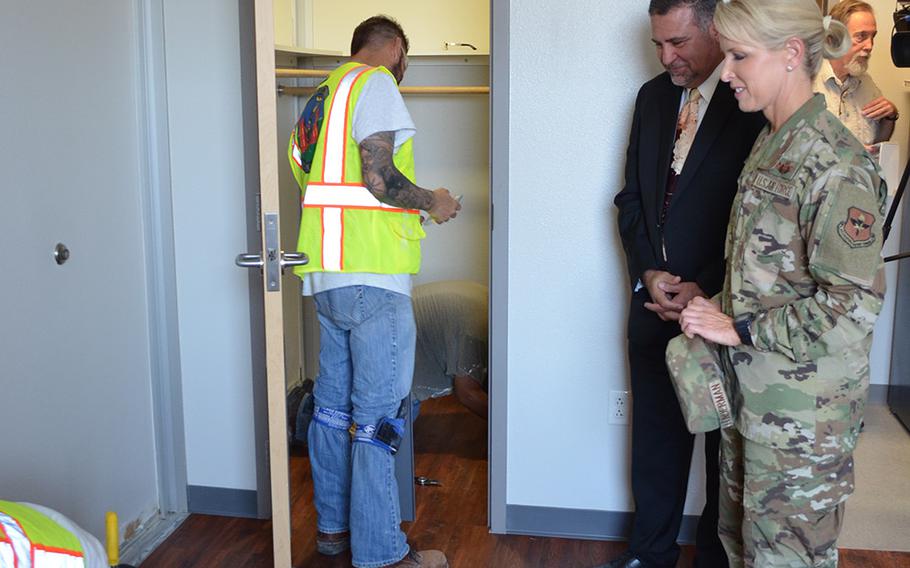 Brig. Gen. Laura Lenderman, commander of the 502nd Air Base Wing and Joint Base San Antonio, and Richard Trevino, director of the 502nd Civil Engineer Group, review mold remediation work underway Thursday in a dorm room in Building 1215 at Lackland Air Force Base in Texas.