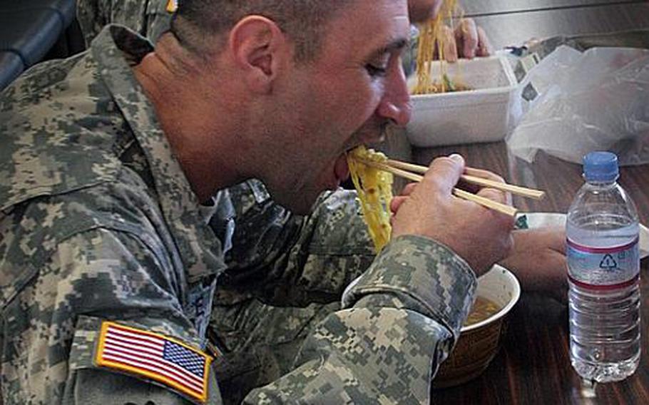 Sgts. 1st Class Andrew Leccese and Joshuah Olson, both with the 5th Battalion Coordination Detachment based at Hickam Air Force Base in Hawaii, eat Japanese ramen on a lunch break during the Yama Sakura exercise Thursday.