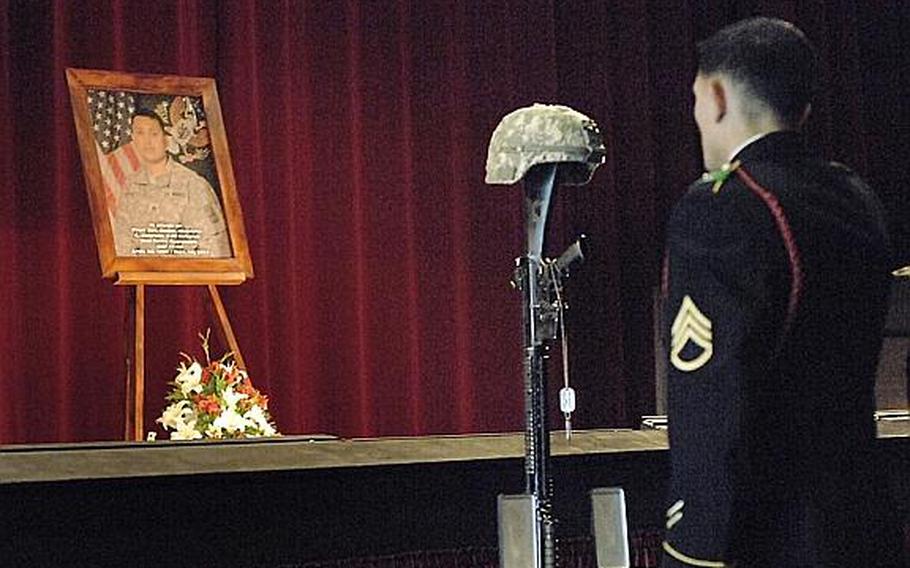 A soldier pays his respects at Wednesday's memorial service for Staff Sgt. Daniel A. Quintana in Grafenwoehr, Germany. A soldier with the 172nd Separate Infantry Brigade, Quintana was killed in Afghanistan on Sept. 10.