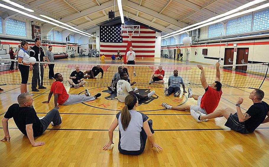 Warrior Transition Unit members and staff from MWR play a game of sitting volleyball at the Kleber gym in Kaiserslautern, Germany, on Nov. 8, 2011. Paralympic instructors from the States led an adaptive sports clinic this week for warrior transition unit soldiers in Europe, as well as for WTU and Army morale, welfare and recreation staffers, so the latter can incorporate a modified sports program at their bases for injured servicemembers and their families.