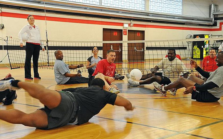 Warrior Transition Unit members and staff from MWR play a game of sitting volleyball at the Kleber gym in Kaiserslautern, Germany, during the week of Nov. 7, 2011. Paralympic instructors from the States led an adaptive sports clinic this week for warrior transition unit soldiers in Europe, as well as for WTU and Army morale, welfare and recreation staffers, so the latter can incorporate a modified sports program at their bases for injured servicemembers and their families.