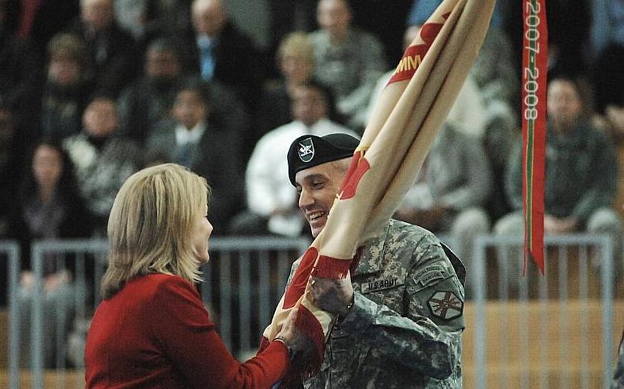 Col. James E. Saenz, 46, accepts the guidon from Installation Management Command Europe director Kathleen Marin as he assumes command of U.S. Army Garrison Grafenwoehr during a Tuesday ceremony.