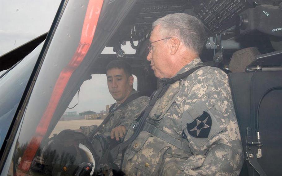 U.S. Army Chief Warrant Officer 4 Dave Lilly, right, prepares to take off on an assignment during which he would pass the 10,000-hour mark in flight time as a rotary wing pilot. Joining Lilly for the  May 1, 2012 milestone flight was his son, Mike, who like his father is a South Korea-based pilot.