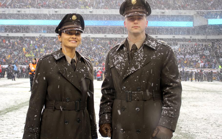 Soldiers modeling the proposed "pinks and greens" daily service uniform pose in their overcoats at Lincoln Financial Field in Philadelphia during the Army-Navy Game in December 2017. 