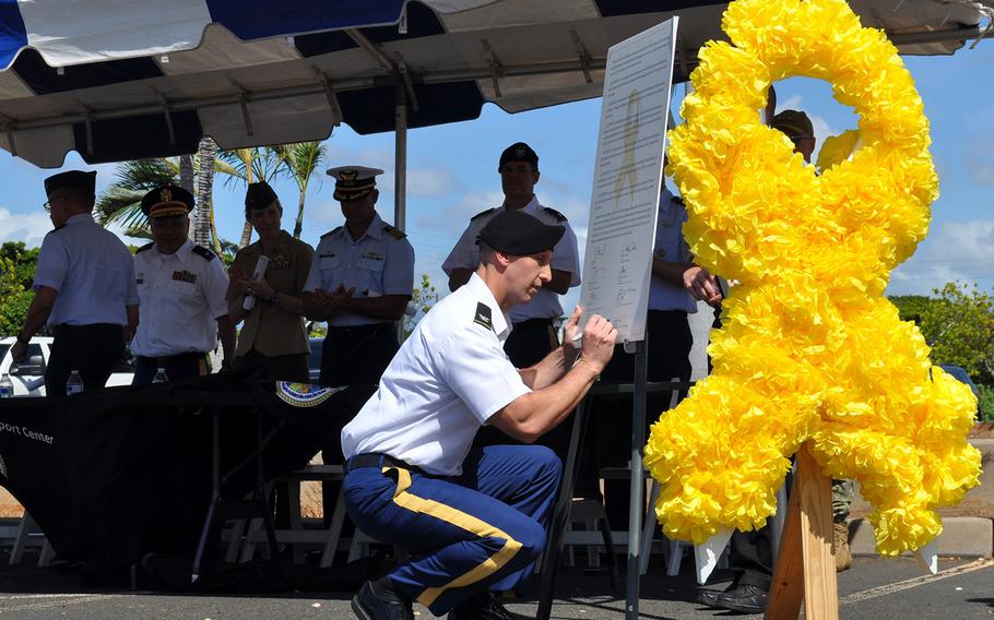 Col. Mark Schoenfeld, 9th Mission Support Command chief of staff, signs the 2019 Joint Services Suicide Prevention Proclamation on World Suicide Prevention Day in Honolulu, Hawaii, Sept. 10, 2019.