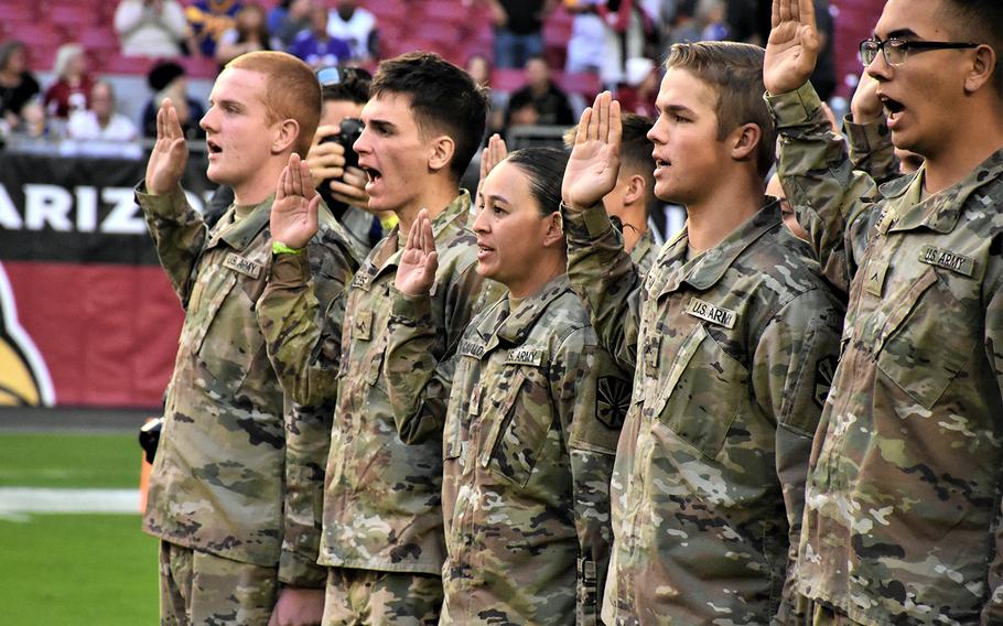 Future soldiers recite the oath of enlistment during a ceremony at State Farm Stadium in Glendale, Ariz., Dec. 1, 2019.