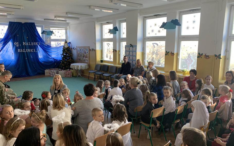 U.S. and Romanian soldiers, along with other guests, await a singing competition at the Miejskie Przedszkole school in Elk, Poland, Feb. 5, 2020.