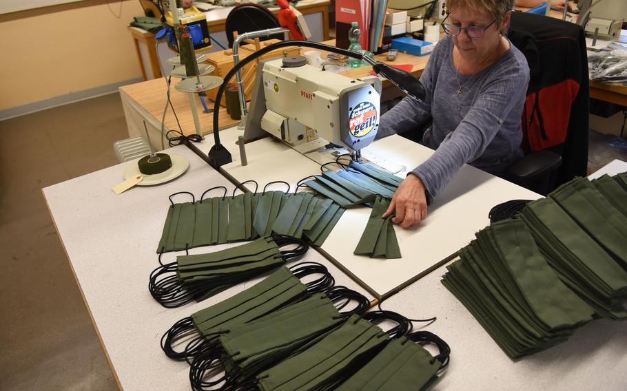 Jutta Gerber, a seamstress, puts the finishing touches on face masks she and her colleagues began making this week for the Theater Logistics Support Center Europe, a mostly German workforce that supports the U.S. Army in Europe.