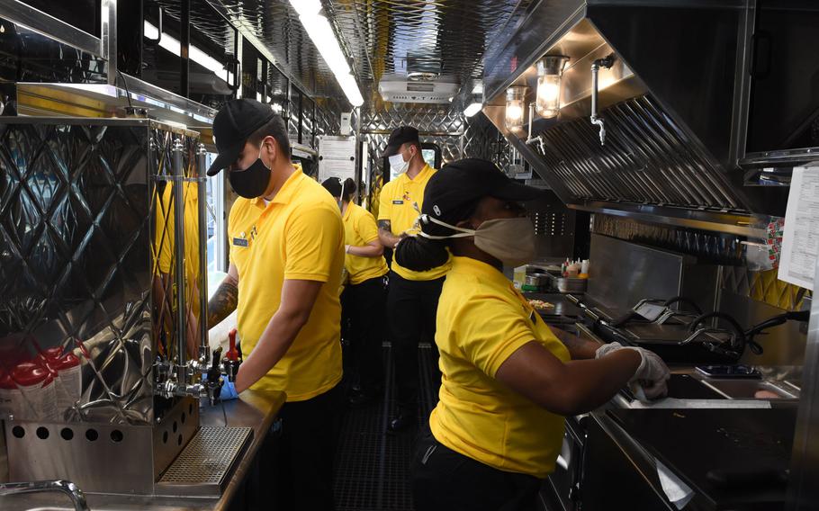 Army culinary specialists with the 55th Quartermaster Company, 16th Special Troops Battalion, 16th Sustainment Brigade, work in the narrow kitchen of the Culinary Outpost, the Army's first food truck in Europe, on Wednesday, June 3, 2020.