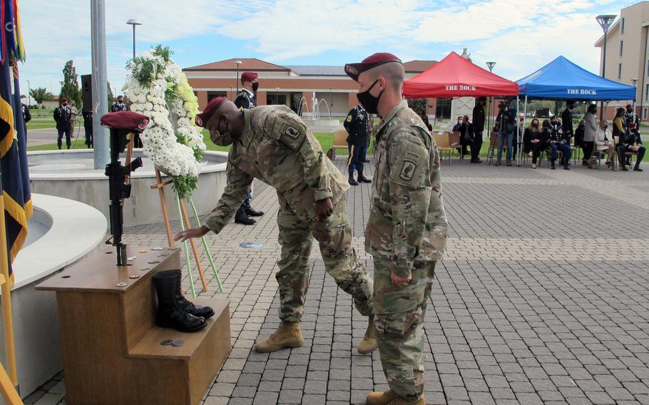 A soldier with the 173rd Airborne Brigade leaves a coin while rendering honors to Sgt. Cade Pendergraft during a memorial Friday, Oct. 16, 2020, at Caserma Del Din in Vicenza, Italy. Pendergraft died in a hiking accident in September 2020.