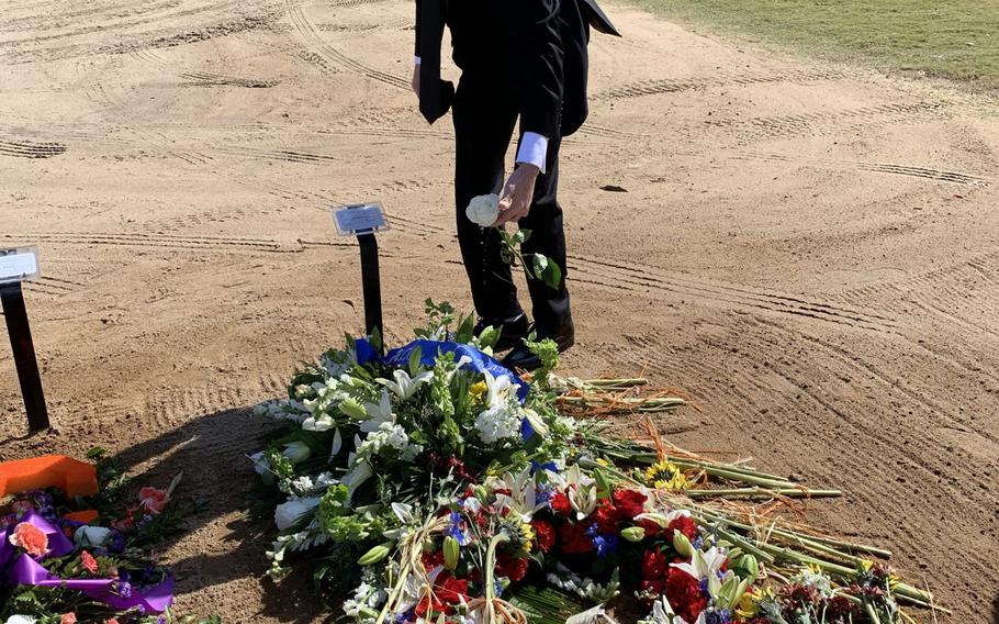 Blake Duncan places a rose at the grave of his brother, Sgt. Cade Pendergraft, at Fort Jackson National Cemetery in Columbia, S.C., on Oct. 7, 2020. Pendergraft, 24, died in a hiking accident in Italy in September.