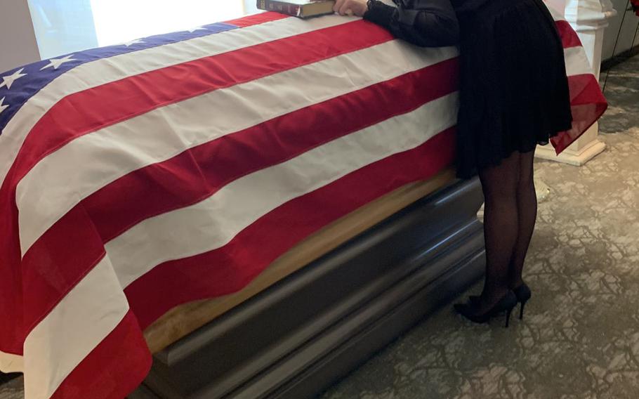 Christina Levering Duncan places her hand on her son Sgt. Cade Pendergraft's Bible at a funeral service at  Fort Jackson National Cemetery in Columbia, S.C. on Oct. 7, 2020. Pendergraft, an NCO with the 173rd Airborne Brigade's 2nd Battalion, 503rd Infantry Regiment, died in a hiking accident in Italy in September.