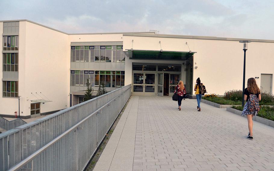 Students walk towards the main entrance of Wiesbaden High School in Hainerberg housing area in Wiesbaden, Germany. The school announced Nov. 3, 2020, that a student has tested positive for the coronavirus. More than two dozen positive cases have been reported within the Wiesbaden military community recently, in line with a spike in case numbers off-post, city officials said.