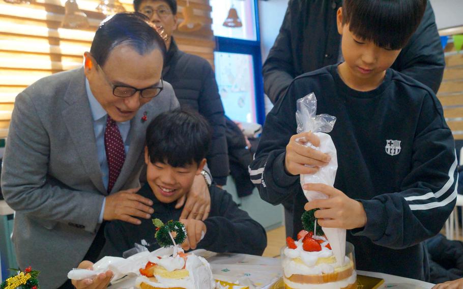 Mayor Park Sang-don makes cakes with children at Ikseonwon Orphanage in Cheonan, South Korea, on Dec. 23, 2023. 
