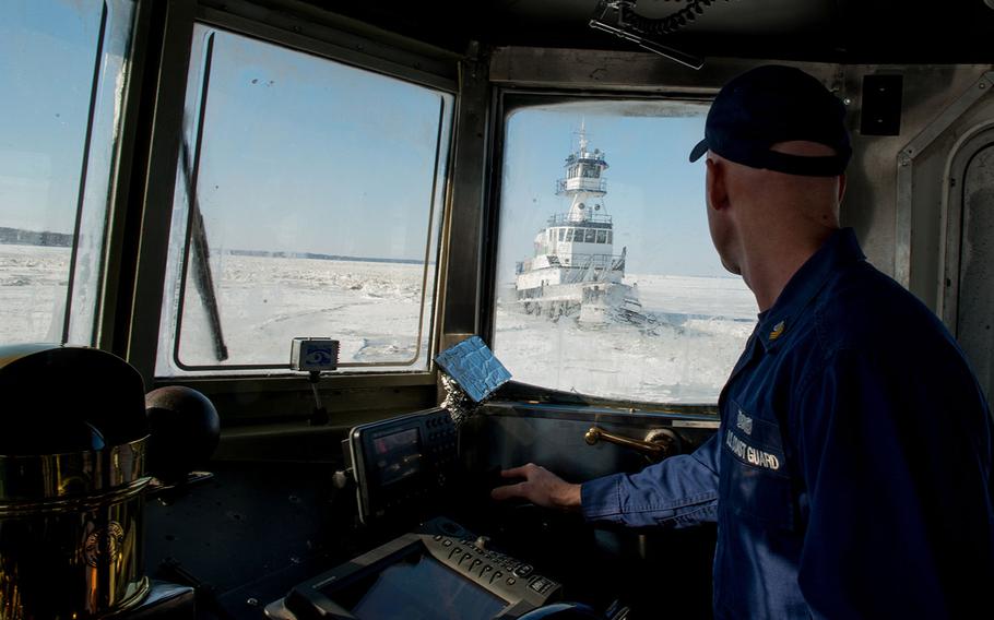 Petty Officer 1st Class Ben Heinze navigates the Coast Guard Cutter Cleat, a 65-foot ice breaking-tug, to help free a local tugboat stuck in the upper Chesapeake Bay ice Friday, Feb. 20, 2015. 