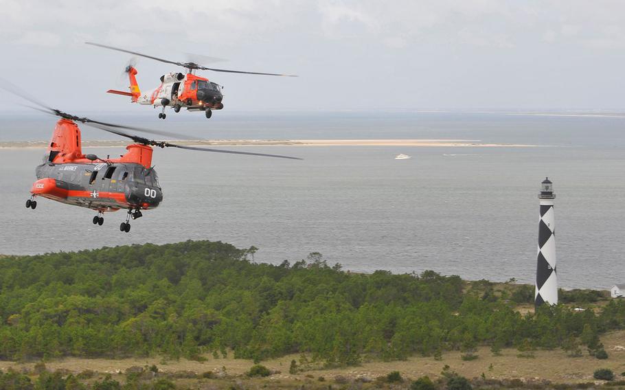 An MH-60 Jayhawk helicopter crew from Air Station Elizabeth City, N.C., flies in formation above a Marine Corps HH-46E Sea Knight helicopter crew from Air Station Cherry Point, N.C. on Tuesday, Sept. 22, 2015, near Cape Lookout.