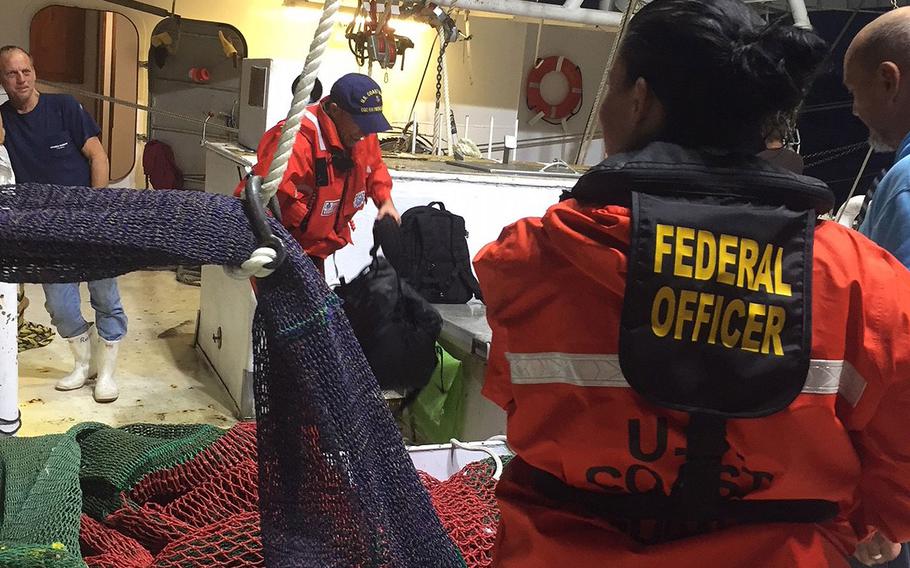 A Coast Guard and National Oceanic and Atmospheric Administration joint boarding team board the 68-foot commercial fishing vessel Ronald E. near the Dry Tortugas Shrimp Sanctuary Preservation on Friday, Jan. 12, 2018.