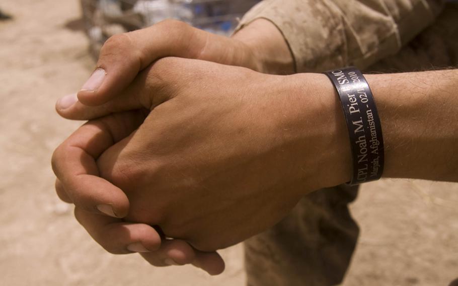 Lance Cpl. Jeffrey P. Grivois, a fire team leader with 3rd Platoon, Company B, 1st Battalion, 3rd Marine Regiment, wears a metal bracelet to honor his friend, Lance Cpl. Noah M. Pier, who was killed in action in January 2011. 