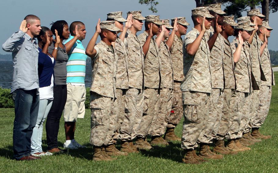 Marines with Combat Logistics Regiment 27, 2nd Marine Logistics Group, participate in a re-enlistment ceremony, Sept. 3, 2010, at Camp Lejeune, N.C. During the ceremony, 17 Marines raised their hands to take an oath swearing to serve their country for an additional term.