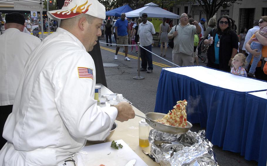 Spc. Javier Muniz, a chef on the Army Pentagon Team, tosses a panfull of sauteed ingredients during the 2012 Military Culinary Competition, which his team won Saturday, Sept. 22, 2012, in Washington, D.C.