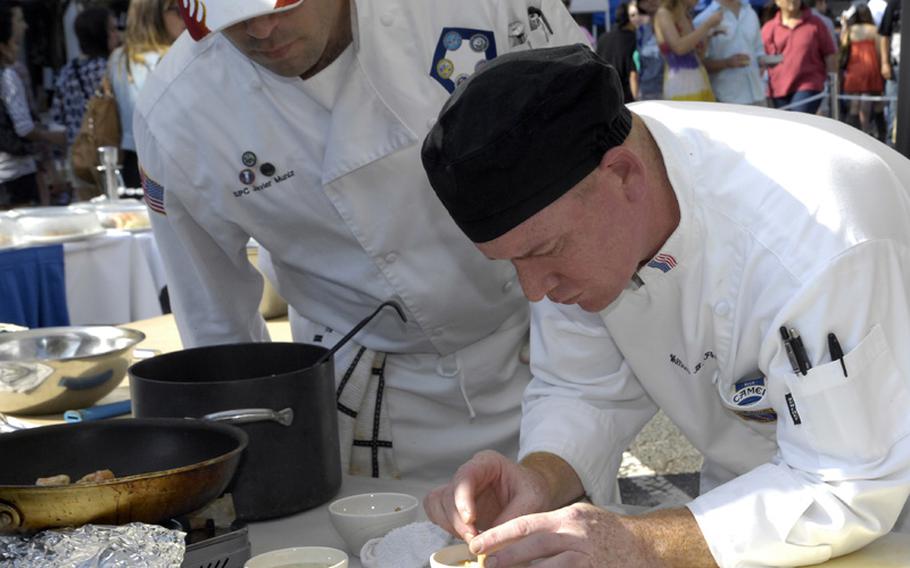 Members of the Army Pentagon Team prepare a meal for the final round of the 2012 Military Culinary Competition, which they won in Washington, D.C. on Sept. 22, 2012. From left are Army Spc. Javier Muniz and Spc. William Pelkey.