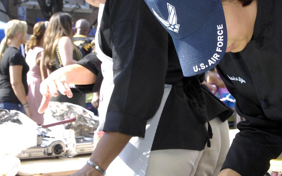 Members of Joint Team United Forces prepare a meal in the final round of the 2012 Military Culinary Competition in which they placed third. From left are Air Force Master Sgt. Teresa Vanderford, Army Sgt. 1st Class Aletha Holiday and Air Force Tech. Sgt. Jessica Styles.