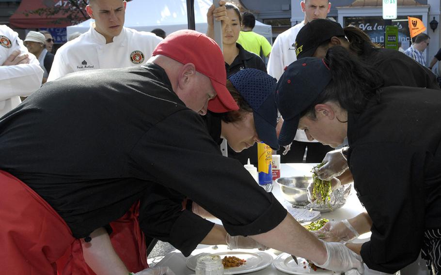 Members of Joint Team United Forces prepare a meal in the final round of the 2012 Military Culinary Competition in which they placed third. From left are Marine Corps Gunnery Sgt. Quentin Reed, Air Force Tech. Sgt. Jessica Styles, Army Sgt. 1st Class Aletha Holiday and Air Force Master Sgt. Teresa Vanderford.