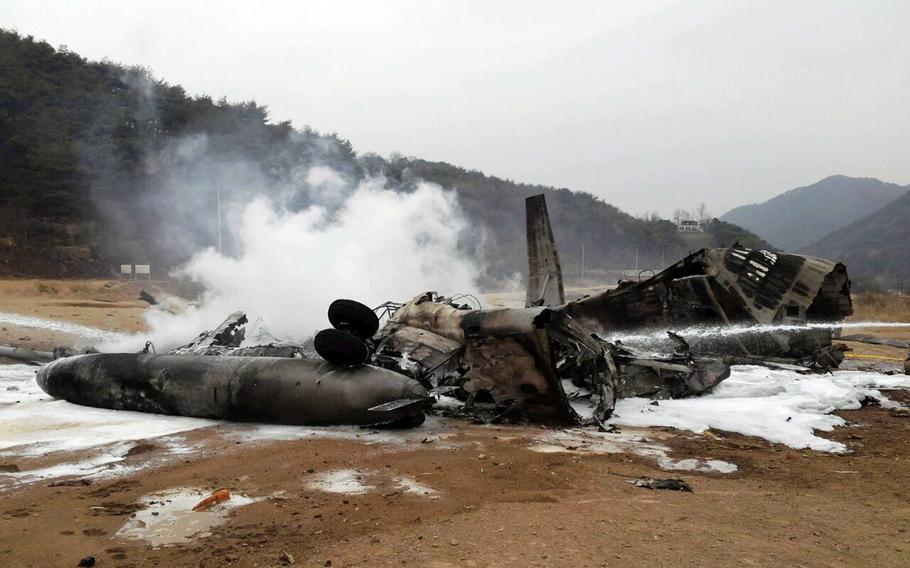 The wreckage of a U.S. Marine helicopter CH-53E Super Stallion helicopter smolders after it made a "hard landing" during an exercise called SsangYong, a Korean Marine Exchange Program and part of the Foal Eagle exercise in Chulwon, north of Seoul, South Korea, Tuesday, April 16, 2013.