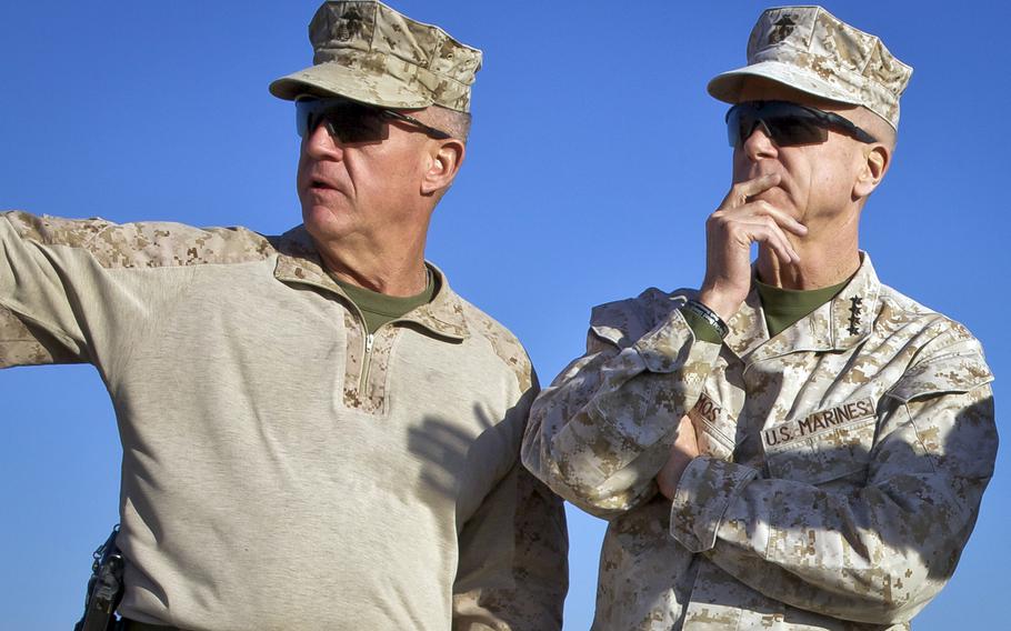 U.S. Marine Corps Gen. James F. Amos, right, the commandant of the Marine Corps, speaks with Maj. Gen. Charles M. Gurganus, the commanding general of the International Security Assistance Force Regional Command Southwest, during a tour of Camp Leatherneck, Helmand province, Afghanistan, Feb. 9, 2013.