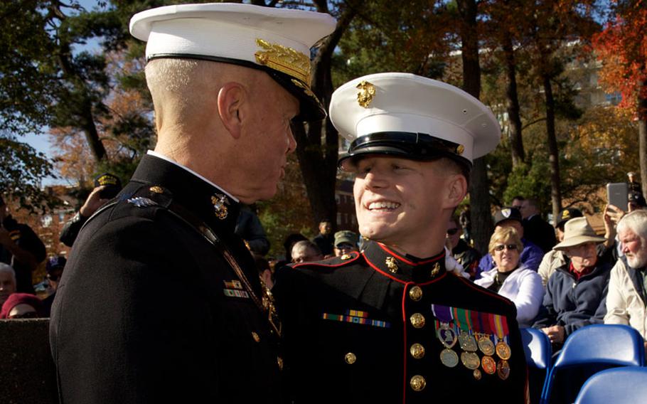 The 35th Commandant of the Marine Corps, Gen. James F. Amos, left, speaks with Cpl. Kyle Carpenter before the annual wreath-laying ceremony at the Marine Corps War Memorial in Arlington, Va., on Nov. 9, 2013.