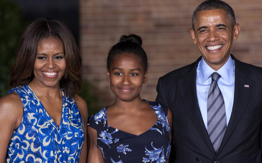 President and Mrs. Barack Obama and daughter Sasha pose for a photo after the evening parade at Marine Barracks Washington, June 27, 2014.