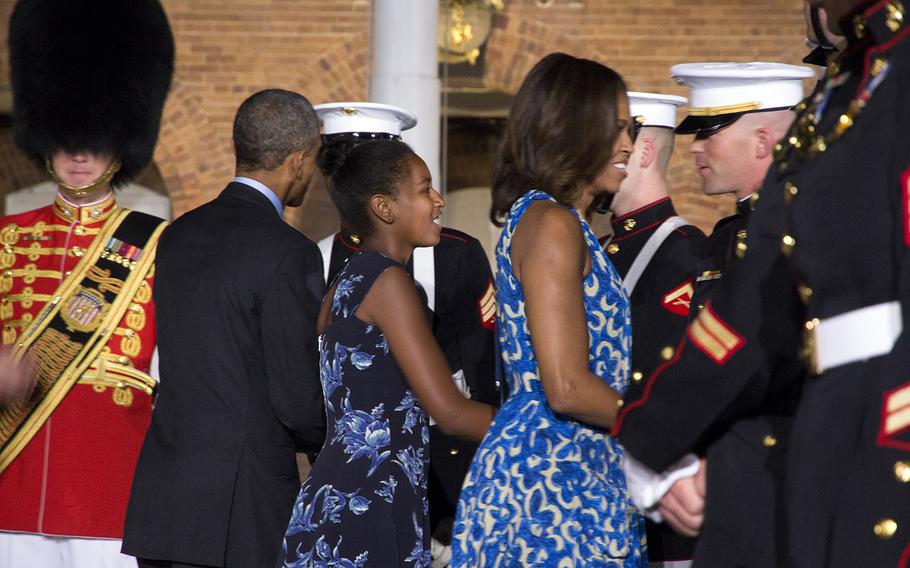 President and Mrs. Barack Obama and daughter Sasha talk with Marines after the evening parade at Marine Barracks Washington, June 27, 2014.