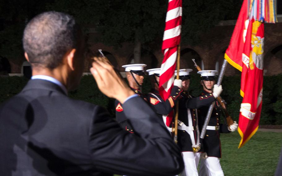 President Barack Obama salutes the colors during the evening parade at Marine Barracks Washington, June 27, 2014.