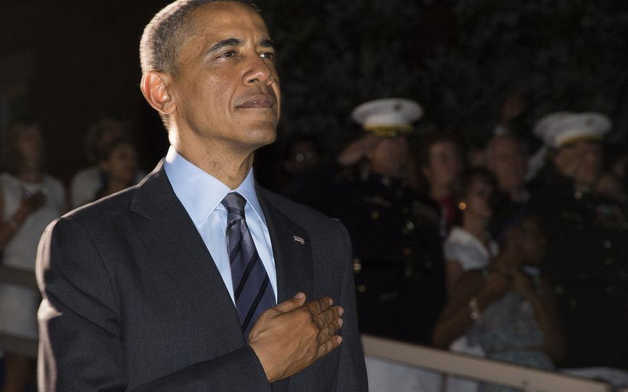 President Barack Obama, during the playing of the national anthem at the evening parade at the barracks on June 27, 2014.