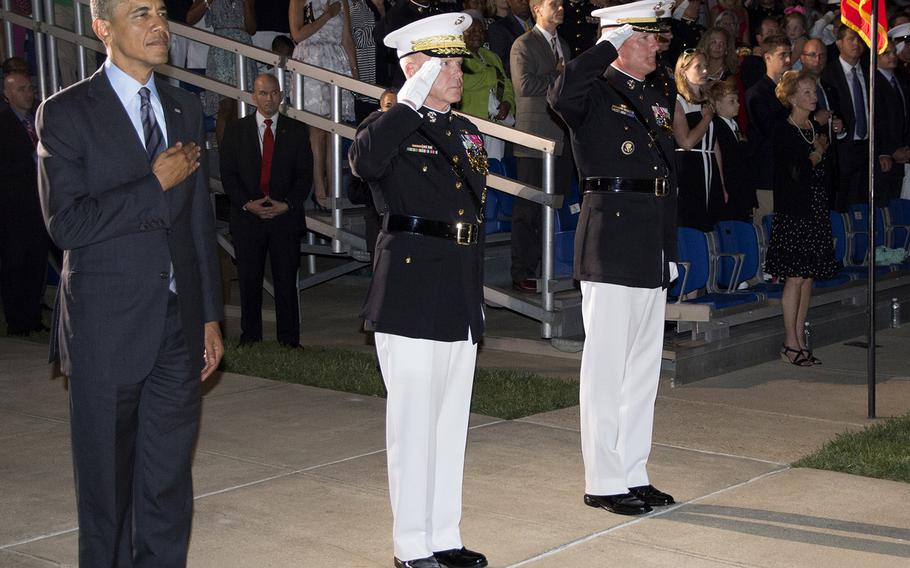 President Barack Obama, Marine Corps Commandant Gen. James Amos and Marine Corps Barracks Washington Commanding Officer Col. Christian Cabaniss stand for the national anthem during the evening parade at the barracks on June 27, 2014.