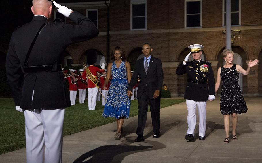 President Barack Obama and first lady Michelle Obama arrive at the evening parade at Marine Barracks Washington with Marine Corps Commandant Gen. James Amos and his wife, Bonnie, on June 27, 2014.