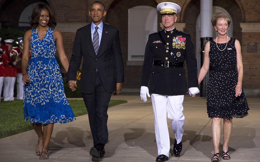 President Barack Obama and first lady Michelle Obama arrive at the evening parade at Marine Barracks Washington with Marine Corps Commandant Gen. James Amos and his wife, Bonnie, on June 27, 2014.