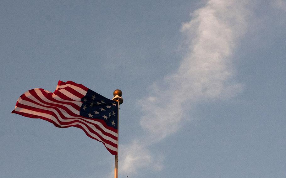 A U.S. flag with 15 stars and 15 stripes, the configuration that would have been flown above Marine Barracks Washington when it was established in 1801,waves in the breeze before the evening parade at the barracks on June 27, 2014.