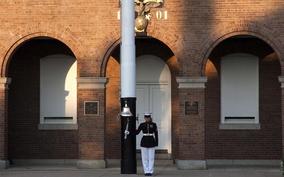 A Marine rings the bell before the evening parade at Marine Barracks Washington, June 27, 2014.