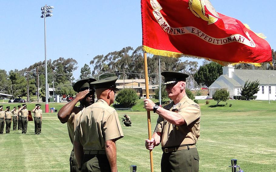 Lt. Gen. John Toolan prepares to pass the flag of I Marine Expeditionary Force to Lt. Gen. David Berger on Friday, at a change of command ceremony at Camp Pendleton. I MEF is made up of more than 50,000 Marines and sailors. 