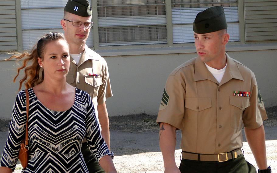 Sgt. Lawrence G. Hutchins III and his wife, Reyna, walk into a pre-trial hearing at Camp Pendleton in October 2014. A Marine general said Thursday, March 6, 2015, that his decision to order a retrial for Hutchins in the killing of an Iraqi civilian was not affected by Navy Secretary Ray Mabus’ statement that the victim “was murdered.”