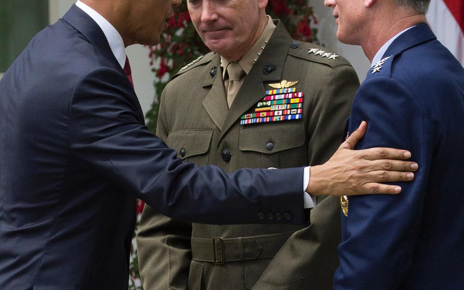 President Barack Obama congratulates Joint Chiefs of Staff chairman nominee Gen. Joseph Dunford, center, and vice chairman nominee Gen. Paul Selva after a Rose Garden ceremony, May 5, 2015.