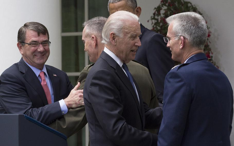 Secretary of Defense Ash Carter congratulates Gen.Joseph Dunford while Vice President talks with Gen. Paul Selva after a Rose Garden ceremony, may 5, 2015.