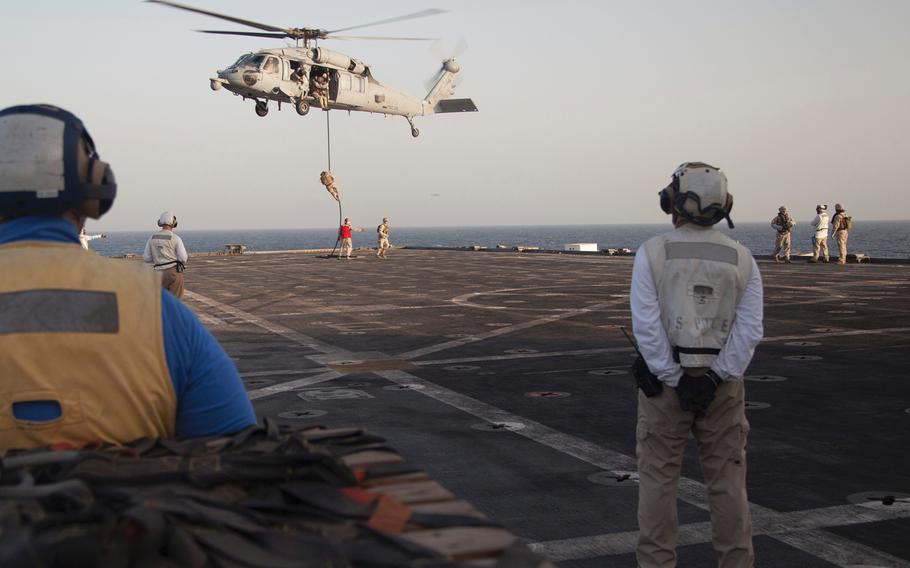 Marines with Company C, 3rd Platoon, of the Fleet Anti-Terrorism Security Team fast-rope out an MH-60 Seahawk during training aboard the afloat forward staging base USS Ponce, Sept. 18, 2015.