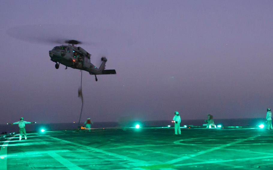 Marines with Company C , 3rd Platoon, the Fleet Anti-Terrorism Security Team, better known as FAST, load onto an MH-60 Seahawk during fast-rope training aboard the afloat forward staging base USS Ponce, Sept. 18, 2015.  FAST trains to provide quick-reaction reinforcement of security at U.S. naval and national assets, including U.S. embassies, for a limited duration.