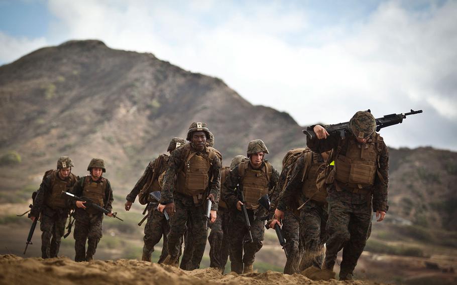 Marines hike along Fort Hase Beach in Hawaii on April 21, 2016