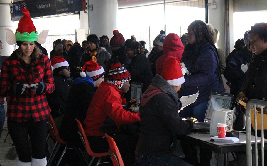 Volunteers at the U.S. Marine Corps Reserve Toys for Tots Program distribute bags of toys for local D.C. residents at RFK Stadium.