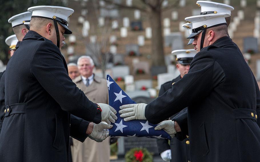 Marine Corps Body Bearers, Bravo Company, Marine Barracks Washington D.C., fold the U.S. flag during a full honors funeral for Maj. Gen. Paul A. Fratarangelo at Arlington National Cemetery, Arlington, Va., Jan. 16, 2018. 