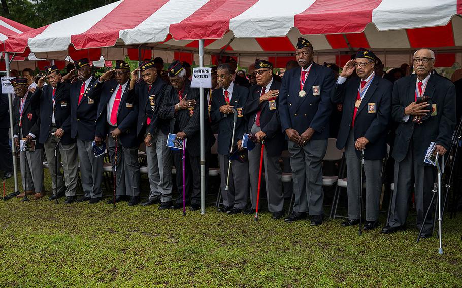 Montford Point Marines salute the colors during the Montford Point Marine Memorial gifting ceremony at the Montford Point Marine Memorial in Jacksonville, N.C., July 25, 2018. 