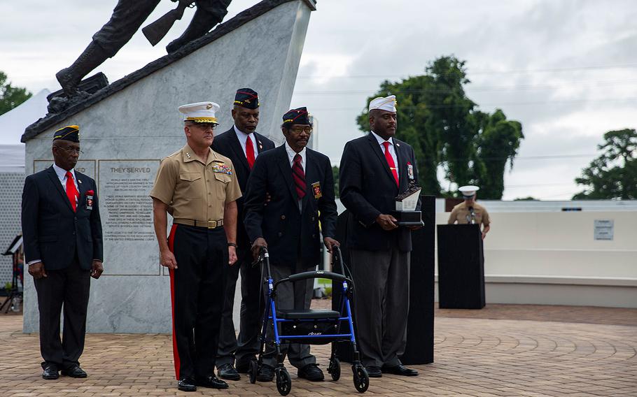 Lt. Gen. Robert F. Hedelund, commanding general, II Marine Expeditionary Force, receives a gift during the Montford Point Marine Memorial gifting ceremony at the Montford Point Marine Memorial in Jacksonville, N.C., July 25, 2018.